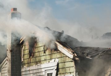 Fire cleanup specialists working on a fire-damaged residential property.