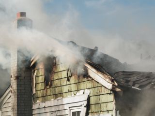 Fire cleanup specialists working on a fire-damaged residential property.